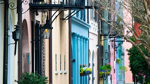 Street view of the fronts of houses on Rainbow Row in Charleston